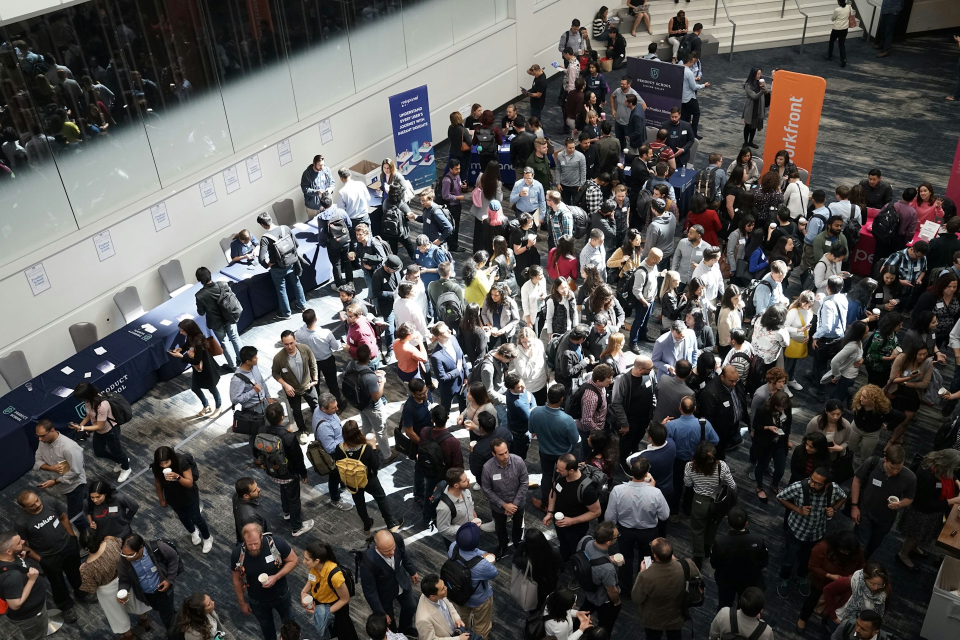 Busy conference exhibition hall with attendees on the floor