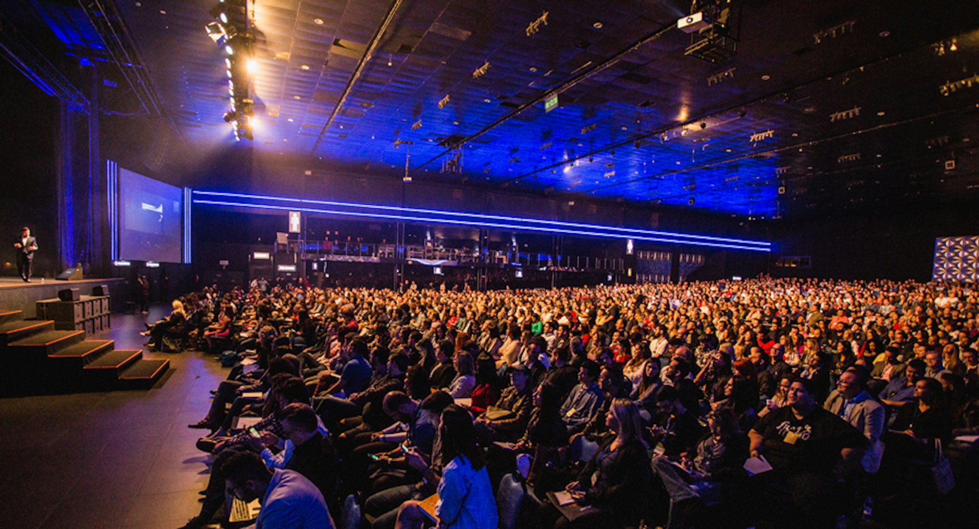 Large conference hall during a keynote under stage lights